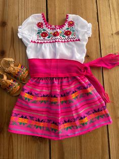 Cute Mexican outfits !!  Embroidery blouse is different on each blouse, also pattern of pink skirt might vary, we choose randomly when shipping.  HUARACHES NOT INCLUDED/ HAIR ACCESSORIES NOT INCLUDED : sold separately, available here at my ESTY shop.  OUTFIT INCLUDES:  Embroidered blouse - each one is unique colorful embroidery.  ONLY FREE STANDARD SHIPPING..  if need faster delivery , you will need to pay ..  ORDER ACCORDING GIRL AGE - my daughter is 8 years old , she is wearing size 7/8. Festive Short Sleeve Sets For Summer, Pink Embroidered Sets For Spring, Pink Blouse For Festive Summer Occasions, Pink Blouse For Summer Festive Occasions, Spring Pink Embroidered Sets, Summer Festive Pink Blouse, Pink Cotton Dress For Fiesta, Pink Festive Blouse For Spring, Festive Short Sleeve Sets For Spring