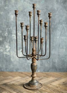 an old metal candelabra on a wooden table