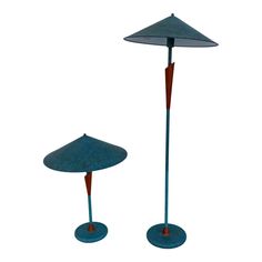 two blue floor lamps sitting next to each other