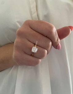 a woman's hand with a diamond ring on it