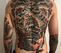 the back of a man with tattoos on his body and chest is covered in an elaborate design