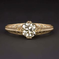 an antique diamond engagement ring in yellow gold