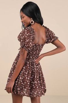 You'll be the first thing on your sweetie's mind in the Lulus Delightful Crush Brown Floral Smocked Puff Sleeve Mini Dress! Lightweight woven fabric, with a burnout design and ditsy floral print throughout, shapes short puff sleeves with elastic cuffs and bow details. Ruffle-trimmed square neckline tops a smocked bodice with a fitted waist. Flaring skirt finishes at a bubble-style mini hem. Fit: This garment fits true to size. Length: Mid-thigh. Size medium measures 26.5" from shoulder to hem. B Cute Dresses With Smocked Bodice For Brunch, Cute Flowy Dress With Smocked Bodice, Cute Fitted Smocked Mini Dress, Cute Smocked Spring Dress With Ruched Details, Cute Mini Smocked Dress With Smocked Bodice, Brown Smocked Bodice Dress For Brunch, Spring Brown Dress With Smocked Bodice, Brown Smocked Back Dress For Brunch, Brown Puff Sleeve Floral Print Dresses