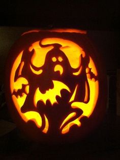 a carved pumpkin with an image of a bat on it