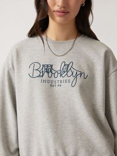 Our Brooklyn Bridge crewneck features an illustrated graphic across the chest. Its relaxed fit and dropped shoulders make it an easy layer, while the brushed fleece backing is soft enough to wear alone. #B1S10137-80018 Fabric: 100% cotton College Graphic Print Drop Shoulder Sweatshirt, Oversized Sporty Sweatshirt With Embroidered Graphics, College Drop Shoulder Graphic Sweatshirt, French Terry Crew Neck Sweatshirt With Text Print, Graphic Print French Terry Crew Top, Crew Neck French Terry Sweatshirt With Text Print, Graphic Print Crew Top In French Terry, Graphic Print Crew Neck Top In French Terry, French Terry Crew Top With Graphic Print