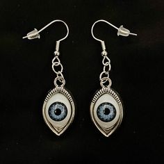 Please read descriptions thoroughly for sizes and materials. This is a pair of earrings with eerily realistic blue glass eyeballs, that seem to always be looking at you. They are a really fun and a little spooky! They are hung from standard hypoallergenic ear wires. Earrings are also available to be hung on 925 Sterling Silver ear wires, clip ons, 16-18mm Surgical Steel Hoops or 12-14mm Surgical Steel Hoops. Make sure to check out my shop for more hair pins, jewelry, earrings, accessories, and a Novelty Blue Drop Earrings, Hypoallergenic Drop Earrings For Halloween, Handmade White Gothic Earrings, White Gothic Handmade Earrings, Novelty Metal Earrings With Ear Wire, Blue Handmade Novelty Earrings, Handmade Blue Novelty Earrings, Halloween Teardrop Jewelry Gift, Eyeball Jewelry