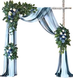 an arch decorated with blue flowers and greenery for a wedding ceremony or special occasion