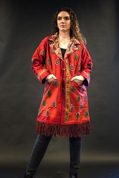 Harriet - a stunning red silk jacket, handcrafted to make you the star of the show. It's an upcycled piece made from a vintage silk traditional Indian garment, embellished with beautiful stones, and adorned with a collar, fleece lining, and leather fringes.  Step out in style and make a statement with Harriet!  More on this jacket: - Unique: Every jacket we up-cycle is one-of-a-kind, enabling you to highlight your individuality and unique style.  - Handmade: This piece is handmade with lots of love and attention to detail, the jacket features beautiful silk embroidery and stone work, adding a touch of luxury and sophistication.   Measurements: Chest: 21" Length with fringe: 38" Length without fringe: 33" Sleeves: 21"   Care instructions: Dry clean Free return on this jacket. Try it and if Fitted Red Outerwear For Festival, Traditional Embellished Outerwear For Fall, Red Fitted Silk Outerwear, Red Silk Fitted Outerwear, Embellished Long Sleeve Silk Outerwear, Red Festive Outerwear For Fall, Fitted Red Embellished Outerwear, Red Embellished Fitted Outerwear, Traditional Silk Long Sleeve Outerwear