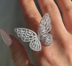 Embrace elegance and whimsy with our Cubic Zirconia Crystal Studded Butterfly Ring. This exquisite piece is a must-have for jewelry lovers who appreciate the delicate beauty of nature combined with a touch of sparkle. Available in three stunning platings - Gold, Rose Gold, and Silver - this ring is designed to complement any outfit and occasion. Key Features: Dazzling Design: The butterfly shape is meticulously crafted and adorned with brilliant cubic zirconia crystals, creating a sparkling effe Elegant Party Rings With Rose Cut Diamonds, Elegant Rose Cut Diamond Rings For Parties, Luxury White Diamond Ring For Party, Luxury Butterfly Ring For Wedding, Luxury Butterfly Ring For Formal Occasions, Party Diamond Cut Diamond Ring, Party Diamond Ring With Brilliant Cut, Luxury Butterfly-shaped Ring For Gift, Luxury Butterfly Rings For Gifts