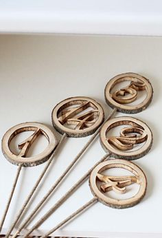 six wooden pins with letters on them sitting on a table