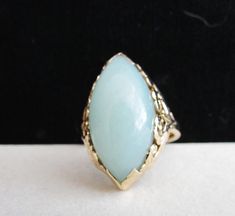 Vintage Estate Mid Century Mings of Honolulu 14K Gold Thick Translucent Light Blue Green Jade Ring Weight: 8.5  grams Ring Front: 25 mm X 15 mm approx 31/32" inches X 37/64" inches Approx Reverse Shank : 2.5 mm Ring Height: 9 mm Marked: 14K Mings Size: 9.5 Vintage Estate Mid Century Ming's of Honolulu 14K Thick Translucent Light Blue Green Marquise Cut Jade Ring Ming's of Honolulu Blue Green Color Jade Ring with Ming's Gold Classic Pierced Scroll Design Gold Mounting  Jade is cut in Wide Marquis Antique Turquoise Gemstone Ring For Formal Occasions, Blue Art Deco Jewelry Stamped 14k, Elegant Turquoise Gemstone Ring For Formal Occasions, Elegant Yellow Gold Turquoise Ring For Formal Occasions, Antique Yellow Gold Turquoise Ring For Anniversary, Vintage Yellow Gold Turquoise Ring For Formal Occasions, Formal Gold Turquoise Ring In 14k Gold, Formal Turquoise Ring In 14k Gold, Blue Cabochon Rings Art Deco Style