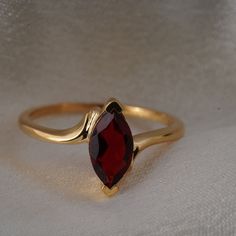 Marquise Shape Red Garnet Ring, 14k Yellow Gold Plated Solitaire Engagement Ring, Women's Statement Ring, Garnet Jewelry, Gift For Her * Material: High Quality Solid 925 Sterling Silver * Finish: Sterling Silver ∙ 14K Gold * I N F O R M A T I O N * Every item is tastefully wrapped and presented in lovely jewellery boxes. Reusable and biodegradable, our jewellery boxes * Are you interested in your own design or looking for advice? Do not hesitate to contact us! We take pride in our quick response Gold Marquise Ruby Ring For Gift, Red Marquise Birthstone Ring For Gift, Red Marquise Cut Birthstone Ring Gift, Red Marquise Cut Gemstone Birthstone Ring, Marquise Garnet Ring As Gift, Gift Marquise Cut Ruby Ring With Prong Setting, Marquise Garnet Red Rings, Gift Ruby Ring With Marquise Cut Birthstone, Marquise Garnet Ring In Red