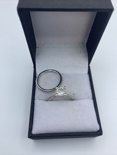 an open box with a ring in it