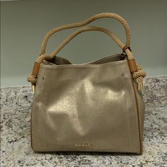 Brand New Gold And Tan Handbag. Very Neutral And Perfect For All Seasons! Straps Can Go Over The Shoulder. 13” Wide 11” High 5 1/2 Inches Deep Gold Bucket Shoulder Bag With Top Carry Handle, Gold Bucket Bag With Top Carry Handle, Gold Shoulder Bucket Bag With Top Carry Handle, Gold Top Handle Shoulder Bag With Leather Handles, Everyday Michael Kors Shoulder Bag With Top Handle, Michael Kors Everyday Shoulder Bag With Top Carry Handle, Michael Kors Leather Satchel For Everyday Use, Gold Hobo Bag With Gold-tone Hardware For Daily Use, Michael Kors Rectangular Canvas Bag