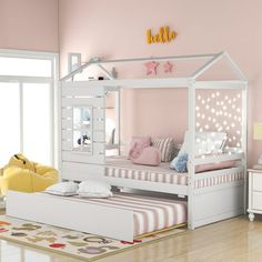 a child's bedroom with pink walls and white furniture