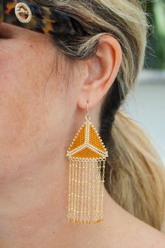 a close up of a person wearing some kind of earrings