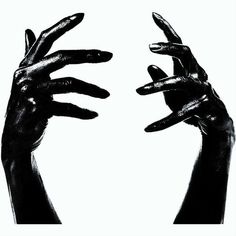 two hands reaching up to each other with their fingers in the air, black and white photograph