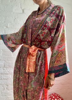 "This is one of a kind patchwork, upcycled silky robe Made free size with wrap tie closing and wide kimono sleeves Easy and fun to wear around the house or outside as a urban boho style, flowy kardigan with jeans and tshirt It is very comfy and feels soft and light the material is colourful indian saree silk made into this unique stylish over all MEAESURE free size length 55\" MATERIAL *saree silk, no lining more available at https://www.etsy.com/shop/AltheaStores? CARE INSTRUCTIONS * Wash in wa Multicolor Long Kimono With Boho Print, Long Multicolor Boho Kimono, Bohemian Long Patchwork Kimono, Multicolor Patchwork Kimono For Spring, Bohemian Robe With Kimono Sleeves And Floral Print, Bohemian Floral Print Festival Robe, Bohemian Robe With Floral Print And Kimono Sleeves, Bohemian Floral Print Robe For Festivals, Bohemian Wrap Robe With Floral Print