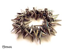 "Gothic Bracelet, Punk Spike Bracelet, Silver Spike Bracelet, Punk Rock Bracelet, Gothic Jewelry, Stud Punk Rock Bracelet, Goth Stud Bracelet, Thorn Bracelet, Unisex Punk Bracelet, Unisex Gothic Jewelry Chunky punk rock bracelet made of plastic silver spikes and beads. The beads are strung on elastic silicone cord.  Choose your wrist size with the drop-down menu. 5.5\" - 14 cm. 6\" - 15.2 cm. 6.5\" - 16.5 cm. 7\" - 17.8 cm. 7.5\" - 19.1 cm. 8\" - 20.3 cm. 8.5\" - 21.6 cm. 9\" - 22.9 cm. ♥ Unique Rocker Style Spike Bracelets For Festivals, Rock Style Spiked Jewelry For Concerts, Edgy Spiked Jewelry For Festivals, Rock Style Spiked Jewelry For Parties, Edgy Festival Jewelry With Spikes, Rock Style Spiked Party Jewelry, Rock Style Party Jewelry With Spikes, Rock Style Metal Bracelet With Spikes, Alternative Style Spiked Bracelets For Festivals