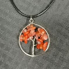 New. Carnelian Tree Of Life Natural Quartz Gemstone Pendant Crystal Necklace. This Tree Of Life Pendant Is Made Of Irregular Crystal Stones With Roots, Trunks And Branches Wrapped In Metal Wire. This Quartz Crystal Pendant Is Lightweight And Comfortable To Wear. Mixed Stones In Different Shades Of Orange, Peach & Pink With Silver Tone Metal. Pendant Is Approximately 1 1/4 Inches Long. Beautiful Orange Colors! Platinum Color Copper Wire Wrapped And Stainless-Steel Tree Of Life Charm Pendant Comes Cotton Cord Necklace, Necklace Orange, Quartz Crystal Pendant, Orange Tree, Tree Of Life Pendant, Crystal Stones, Shades Of Orange, Metal Wire, Metal Pendant