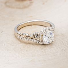 a diamond ring on a wooden surface