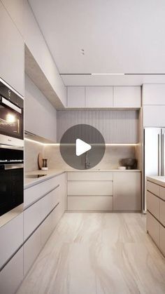 an image of a kitchen setting with white cabinets and wood flooring, including two ovens