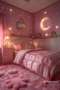 a bedroom decorated in pink with stars and moon decorations