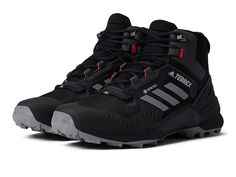 adidas Outdoor Terrex Swift R3 Mid GTX(r) - Men's Shoes : Black/Grey/Solar Red : Explore the mountains and hike through new routes wearing the adidas Outdoor Terrex Swift R3 Mid GTX that offer a waterproof and a breathable performance. Textile and synthetic upper with GORE-TEX membrane. Textile lining and removable insole. Pull-on style with lace-up closure. Round toe. Heel pull tab. Molded heel cup. adidas branding on the upper. EVA midsole and molded sockliner. Continental rubber outsole. Impo Adidas Hiking Shoes, Gore Tex Hiking Boots, Adidas Boots, Mens Hiking Shoes, Adidas Sneakers Mens, Adidas Branding, Adidas Shoes Mens, Tactical Shoes, Mens Hiking Boots