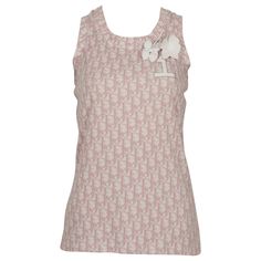 CHRISTIAN DIOR by JOHN GALLIANO vintage tank top featuring an all over trotter monogram pattern in girly pink on a white background, 2 white viny flower brooches and a crystal embellished Nº1 patch on the chest. Label reads CHRISTIAN DIOR BOUTIQUE Paris. Made in France. Size tag reads : F 38 / GB 10 / D 36 / USA 6. Please refer to measurements. Composition tag reads : 100% Cotton. Indicative measurements taken laid flat and unstretched (double bust) : shoulders approx. 22 cm (8.66 inches) / bust Dior Cartoon, J Adore Dior, Dior By John Galliano, Christian Dior Designer, Dior Boutique, Dior Jacket, Vintage Tank Top, 20th Century Fashion, Dior Logo