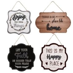 four wooden signs hanging from the side of a white wall, each with different sayings