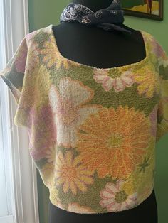 Hit the beach in this vintage towel top! Retro seventies style floral in green pink yellow and orange, so cute. Boxy style sleeveless fit. This is such an adorable top to toss on over your swimsuit for a day on the water, guaranteed to be one of a kind! Approximate size women's L depending on desired fit, see measurements below. The towel certainly had some wear but I have avoided using any portions with holes, and trimmed away any loose threads of terry. She has been loved, and is ready to star Towel Shirt, Seventies Style, Summer Cover Up, Vintage Towels, Seventies Fashion, Terry Cloth, Pink Yellow, Hand Sewn, Womens Clothing Tops