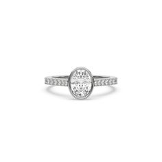 Oval Diamond Bezel Engagement Ring is made with an oval cut diamond set in a bezel setting on a pave diamond band made with round brilliant cut diamonds.Details: - Made to Order- Focal Diamond Weight: 1.00 CT, 1.50 CT, 2.00 CT, 2.50 CT, 3.00 CT- Accent Diamond Weight: 0.25 CT - 0.35 CT (Carat weight varies based on chosen Focal Diamond)- Focal Diamond Cut: Oval- Accent Diamond Cut: Round - Diamond Type: Lab Grown Diamond (CVD, HPHT)- Diamond Clarity: VS - Diamond Color: Colorless (DEF)- Setting Classic Oval Diamond Ring With Pave Setting, Oval Diamond Ring With Bezel Setting, Oval White Gold Diamond Ring With Bezel Setting, Oval Diamond White Diamond Ring With Pave Setting, Oval Diamond White Ring With Pave Setting, Oval White Gold Diamond Ring With Pave Setting, Bezel Engagement Ring, Pave Diamond Band, Bezel Ring