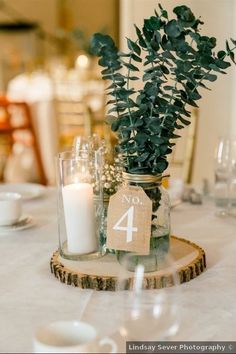 the table is set with candles and greenery in mason jars, which are labeled no 4