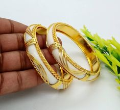 ❖ ❖ ❖ Features: ❖ An Indian styled Polki Bangles. ❖ Made from fine Quality Brass with Gold Platting. ❖ Ready to be given as a gift. ❖ Easy and Convenient way to Wear. ❖ It looks prettier than the images. Direct Images on hand is also attached. Size of Bangle & Other Details: ❖ Size:- Choose Your Size ❖ Quantity:- 6 pieces 1 bangle set ❖ Material:- Fine Quality Brass with Gold Platting This gold plated unique bangles are glamorously impressive, yet subtle, the design is clean and extremely ac Indian Wedding Bangles, Polki Bangles, Wedding Bangles, Designer Bangles, Pearl Cluster Ring, Unique Bangle, Bangles Set, Flower Engagement Ring, Bangles Making