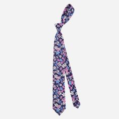 With its bold floral pattern and pops of pink and blue, this linen tie will make a stylish statement at your next destination wedding. | Men's Tie Bar: Tossed Lillies Tie - Skinny, In Navy, Linen, Floral Fitted Blue Floral Suit And Tie Accessories, Blue Floral Print Suit And Tie Accessories For Spring, Adjustable Blue Floral Print Tie, Spring Blue Floral Print Suit And Tie Accessories, Summer Floral Print Ties, Spring Floral Print Fitted Suit And Tie Accessories, Summer Wedding Suit And Tie Accessories With Floral Print, Floral Print Suit And Tie Accessories For Summer Weddings, Pink Floral Print Ties For Summer