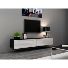 an entertainment center with a large flat screen tv mounted on it's sideboard