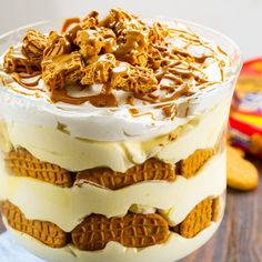 a layered dessert in a glass dish with the words nutter butter banana pudding on top