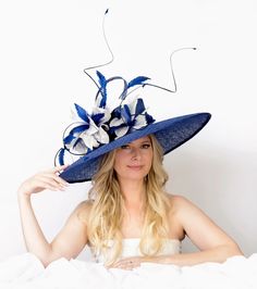 A show stopper! This oversized hat is an absolute stunner! Made of triple layer of sinamay, covered with bird eye straw net for extra texture and adorned with handmade hand painted silk abaca flowers. Quills give an extra majestic height and volume. Can be done in a wide variety of colors and head sizes Horse Race Hats, Blue Headpiece, Black And White Hats, Royal Ascot Hats, Oversized Hat, Couture Hats, Ascot Hats, Navy Hats, Large Hats