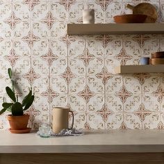 a kitchen counter topped with pots and cups