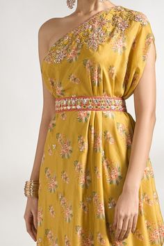 Mustard one shoulder dress with floral print and gota, zari thread, sequin, cutdana embroidered neckline. Paired with embroidered belt. - Aza Fashions Embellished Designer Dresses For Festivals, Embellished Dresses For Designer Wear At Festivals, Festive Embellished Dresses, Bollywood Style Saree Dress For Summer, Summer Festive Saree Dress, Bollywood Summer Saree Dresses, Yellow Dress With Floral Embroidery For Reception, Elegant Summer Saree Dress, Embellished Yellow Saree Dress