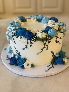 a white cake with blue and white flowers on it