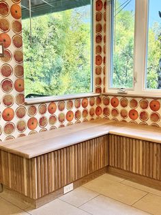 a corner bench in front of a window with an artistic wallpaper pattern on it