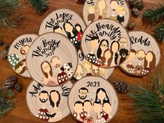 six personalized wedding coasters on a wooden table with pine cones and evergreen branches