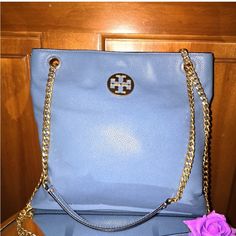 Retail Price: $428.00 Sleek Leather Creates A Minimalist Tote That Is Accentuated With Gold-Tone Chain Hardware And A Classic Tory Burch Logo. Dual Partial Chain Top Handles Magnetic Top Closure Exterior Features 1 Slip Pocket Interior Features 1 Zip Pocket And 1 Slip Pocket Measurement: 10.5" Height, 11" Width, 3" Depth. 12.5" Strap Drop, 23.5" Crossbody Strap Drop (Interior Capacity Medium) Material: Leather Color: Blue Yonder Some Corner Wear Refers To Pictures Bundle And Save With Me Blue Tote Shoulder Bag With Chain Strap, Light Blue Shoulder Bag With Gold-tone Hardware, Luxury Turquoise Tote Shoulder Bag, Blue Tote Bag With Gold-tone Hardware, Minimalist Tote, Blue Leather Bag, Blue Crossbody Bag With Gold-tone Hardware, Chain Top