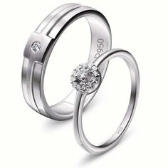 two white gold wedding rings with diamonds on each side and one diamond in the middle