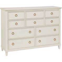 a white dresser with gold handles and drawers