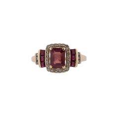 This stunning natural ruby and diamond ring is the perfect way to show your unique style. Featuring .14ctw single cut diamonds, .50ctw square step cut rubies and a .50ct center natural light flux treated ruby, this ring will make a bold statement. Crafted from 14k rose gold for a beautiful finish, this ring will be sure to stand out. The ring is currently a size 7, and can be adjusted to fit your finger for a small fee. Red Baguette Cut Diamond Accent Rings, Ruby Jewelry With Diamond Accents In Baguette Cut, Baguette Cut Ruby Jewelry With Diamond Accents, Rectangular Ruby Ring Fine Jewelry, Red Emerald-cut Diamond Accented Jewelry, Ruby Jewelry With Diamond Accents, Emerald Cut, Rectangular Ruby Ring In Fine Jewelry Style, Emerald Cut Ruby Jewelry With Diamond Accents, Red Emerald-cut Rings With Diamond Accents