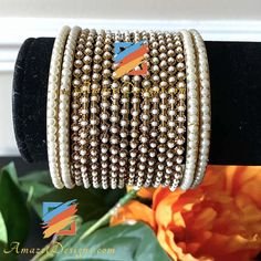 Moti Bangles Bangle Set can be customized with any Bangle or Kada. - Talk to us to Add or Remove any bangle and adjust pricing. - Price shown is for Both Hands Explore more INDIAN BANGLES, Indian Kada, CHURA, Bridal Kada 👉 PUNJABI BRIDAL JEWELLERY ONLINE 💁🏻‍♀️Kamalika, US ⭐️⭐️⭐️⭐️⭐️ Great collection. Prompt delivery. Exceeded my expectations- more beautiful than the picture. Love the packaging which comes with a 'Thank You' note. Great customer care. Very happy with whatever I purchased. High Adjustable Hand Set Bracelets For Festivals, Adjustable Hand-set Bracelets For Festivals, Adjustable Hand Set Bangle For Celebration, Adjustable Hand-set Bangle For Celebrations, Wedding Metal Beaded Pearl Bracelet, White Metal Pearl Bangle Bracelet, Elegant Adjustable Cuff Bracelet For Festivals, Adjustable Elegant Cuff Bracelet For Festivals, Gold Beaded Bangle Jewelry