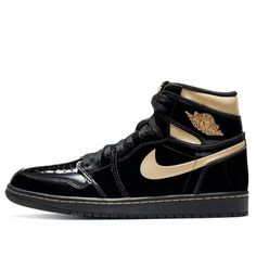 Nike Air Jordan 1 Retro High OG “Black Metallic Gold” featured black and metallic gold color scheme. made of black patent leather with golden lacquer Swooshes and ankle collar. Other details include a nylon tongue with the "Nike Air" trademark affixed to the black rubber sole. Classic Gold Sneakers For Streetwear, Luxury Gold Sneakers With Rubber Sole, Gold Sneakers With Contrast Sole For Streetwear, Luxury Patent Leather Sneakers For Streetwear, Luxury Patent Leather Streetwear Sneakers, Gold Leather Sneakers With Rubber Sole, Gold High-top Leather Sneakers, Luxury Black Patent Leather Sneakers, Black Patent Leather Sneakers With Round Toe