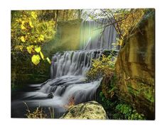 a waterfall in the middle of a forest